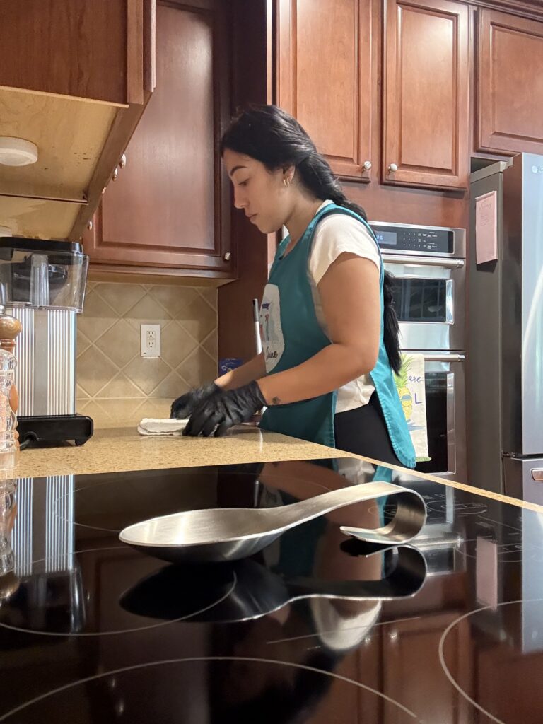 Fresh Shine Cleaning Professional Wiping down counter in kitchen